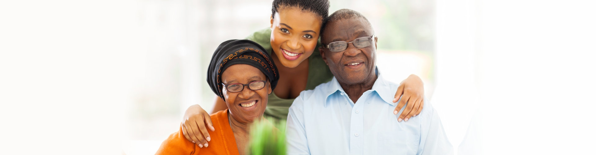 old couple smiling with their caregiver